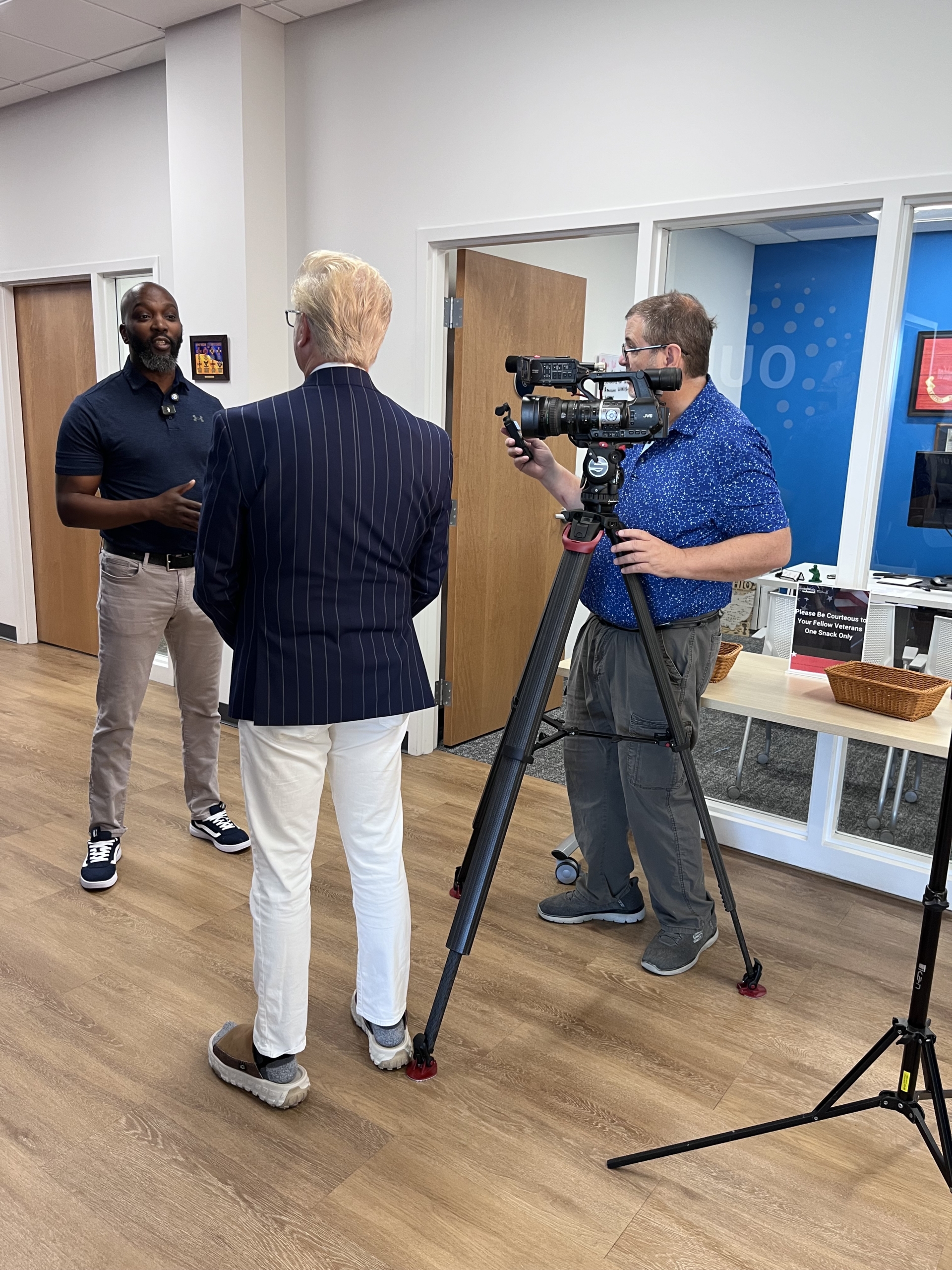 Nate Davis standing in the Military and Veteran Center being interviewed by a FOX19 reporter and camera person.